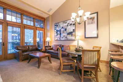 a living room with a couch and a table at Catamount Lodge 409 by East West Hospitality in Truckee