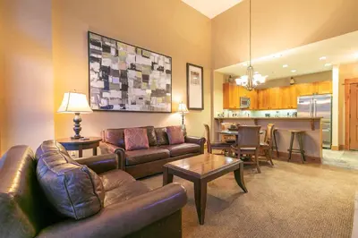 a living room with a couch and a table at Catamount Lodge 409 by East West Hospitality in Truckee