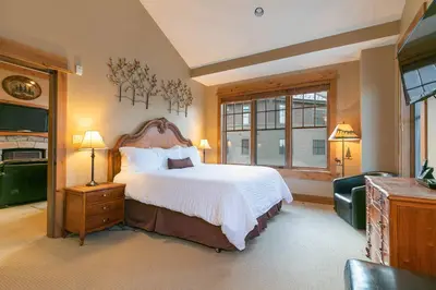 a bedroom with a large bed and a window at Catamount Lodge 404A by East West Hospitality in Truckee