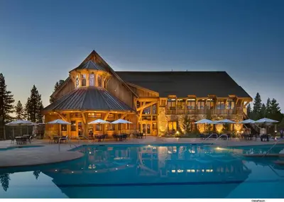 a large building with a pool in front of it at Fairway Drive 13136 by East West Hospitality in Truckee