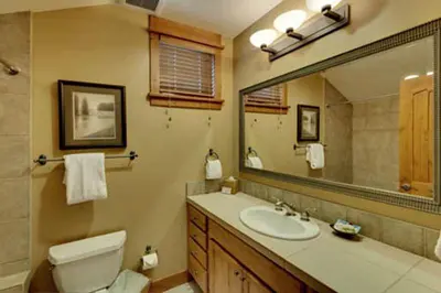 a bathroom with a sink and a toilet and a mirror at Gold Rush Trail 12560 by East West Hospitality in Truckee