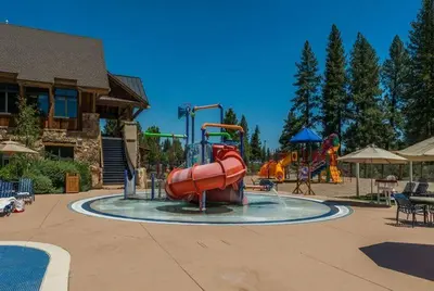 a water park with a playground with a water slide at Gold Rush Trail 12560 by East West Hospitality in Truckee