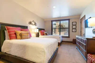 a bedroom with two beds and a window at Great Bear Lodge 206 by East West Hospitality in Truckee