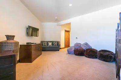 a living room with a couch and a tv at Great Bear Lodge 206 by East West Hospitality in Truckee