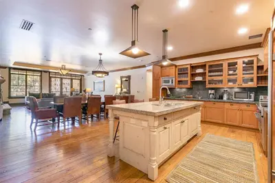 a large kitchen and dining room with a large island at Great Bear Lodge 206 by East West Hospitality in Truckee