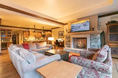 a living room with two couches and a fireplace at Great Bear Lodge 201 by East West Hospitality in Truckee