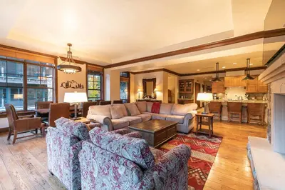 a living room with two couches and a table at Great Bear Lodge 201 by East West Hospitality in Truckee