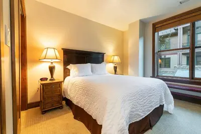 a bedroom with a large bed and a window at Great Bear Lodge 201 by East West Hospitality in Truckee