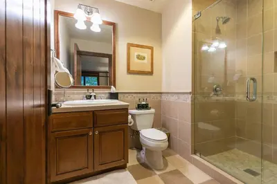 a bathroom with a toilet and a shower and a sink at Great Bear Lodge 201 by East West Hospitality in Truckee