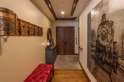 a hallway with a red couch and a door at Great Bear Lodge 306 by East West Hospitality in Truckee