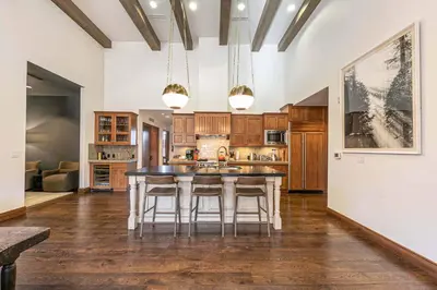 a kitchen with a table and chairs in a room at Great Bear Lodge 501 by East West Hospitality in Truckee