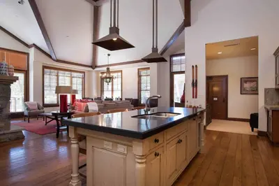 a kitchen with a sink and a living room at Great Bear Lodge 501 by East West Hospitality in Truckee