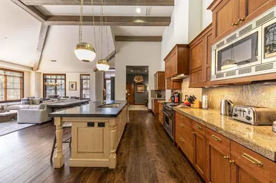 a large kitchen with wooden cabinets and a large island at Great Bear Lodge 501 by East West Hospitality in Truckee