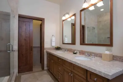 a bathroom with two sinks and a shower at Great Bear Lodge 501 by East West Hospitality in Truckee