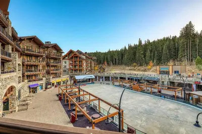 a ski lodge with a pool in the middle at Great Bear Lodge 302 by East West Hospitality in Truckee