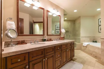 a bathroom with two sinks and a large mirror at Great Bear Lodge 302 by East West Hospitality in Truckee