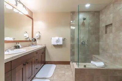 a bathroom with a shower and a sink at Great Bear Lodge 504 by East West Hospitality in Truckee