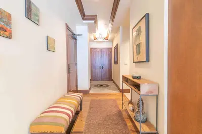 a hallway with a couch and a table in a room at Great Bear Lodge 504 by East West Hospitality in Truckee