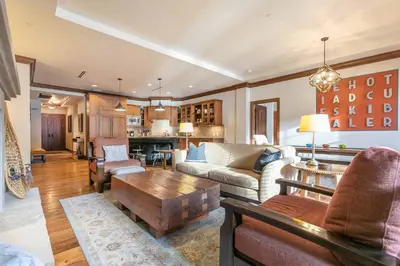 a living room with a couch and a table at Great Bear Lodge 504 by East West Hospitality in Truckee