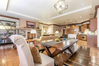 a kitchen and living room with a table and chairs at Great Bear Lodge 504 by East West Hospitality in Truckee