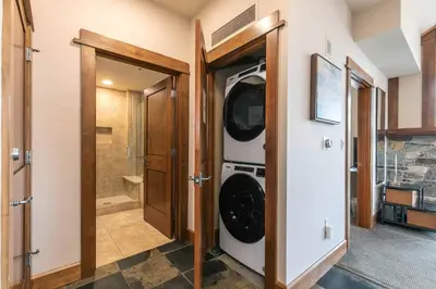 a laundry room with a washer and dryer at Iron Horse Lodge North 309 by East West Hospitality in Truckee
