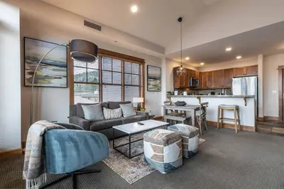 a living room with a couch and a table at Iron Horse Lodge North 309 by East West Hospitality in Truckee