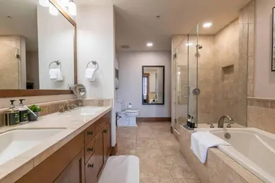 a bathroom with two sinks and a tub and a shower at Iron Horse Lodge North 309 by East West Hospitality in Truckee