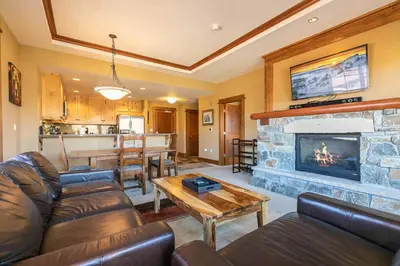 a living room with a couch and a fireplace at Iron Horse Lodge North 209 by East West Hospitality in Truckee