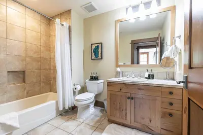 a bathroom with a tub and a toilet and a sink at Iron Horse Lodge South 406 by East West Hospitality in Truckee