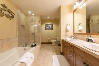 a bathroom with a tub and two sinks and a shower at Iron Horse Lodge North 310 by East West Hospitality in Truckee
