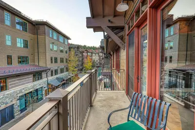 a balcony with a bench on a building at Iron Horse Lodge North 310 by East West Hospitality in Truckee