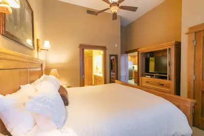 a bedroom with a large bed with white pillows at Iron Horse Lodge North 310 by East West Hospitality in Truckee