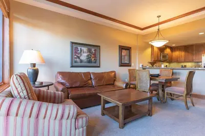 a living room with a couch and a table at Iron Horse Lodge South 305 by East West Hospitality in Truckee