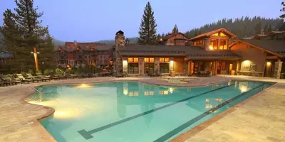a large swimming pool in front of a house at Iron Horse Lodge South 305 by East West Hospitality in Truckee