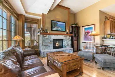 a living room with a couch and a fireplace at Iron Horse Lodge South 502 by East West Hospitality in Truckee
