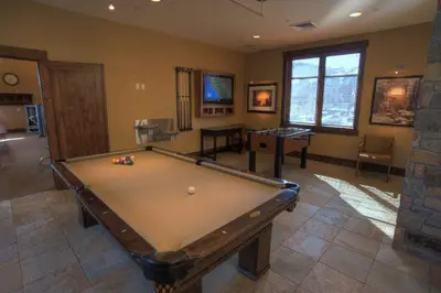 a room with a pool table in a house at Iron Horse Lodge North 107 by East West Hospitality in Truckee