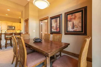 a dining room with a wooden table and chairs at Iron Horse Lodge North 107 by East West Hospitality in Truckee
