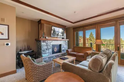 a living room with a couch and a fireplace at Iron Horse Lodge North 205 by East West Hospitality in Truckee