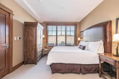 a bedroom with a large bed and a window at Iron Horse Lodge North 205 by East West Hospitality in Truckee