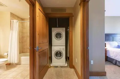 a bathroom with a washer and dryer in a room at Iron Horse Lodge North 205 by East West Hospitality in Truckee
