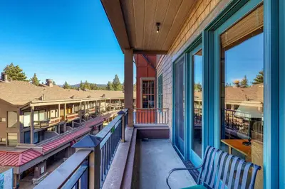 a balcony with benches and windows on a building at Iron Horse Lodge North 205 by East West Hospitality in Truckee