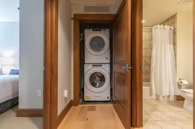 a bathroom with a washer and dryer in a room at Iron Horse Lodge North 206 by East West Hospitality in Truckee