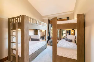 two wooden bunk beds in a room with at Iron Horse Lodge North 305 by East West Hospitality in Truckee