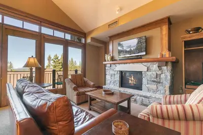 a living room with a couch and a fireplace at Iron Horse Lodge North 307 by East West Hospitality in Truckee