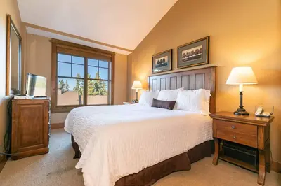 a bedroom with a large bed and a window at Iron Horse Lodge North 307 by East West Hospitality in Truckee
