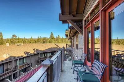 a balcony with chairs and a view of a field at Iron Horse Lodge North 307 by East West Hospitality in Truckee