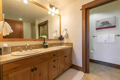 a bathroom with two sinks and a large mirror at Iron Horse Lodge North 207 by East West Hospitality in Truckee