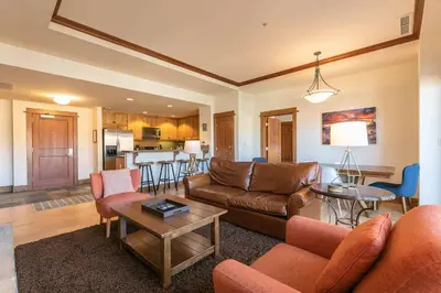 a living room with a couch and a table at Iron Horse Lodge North 207 by East West Hospitality in Truckee