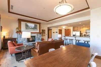 a living room with a couch and a dining room table at Iron Horse Lodge North 207 by East West Hospitality in Truckee