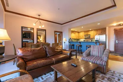 a living room with a couch and a table at Iron Horse Lodge South 209 by East West Hospitality in Truckee